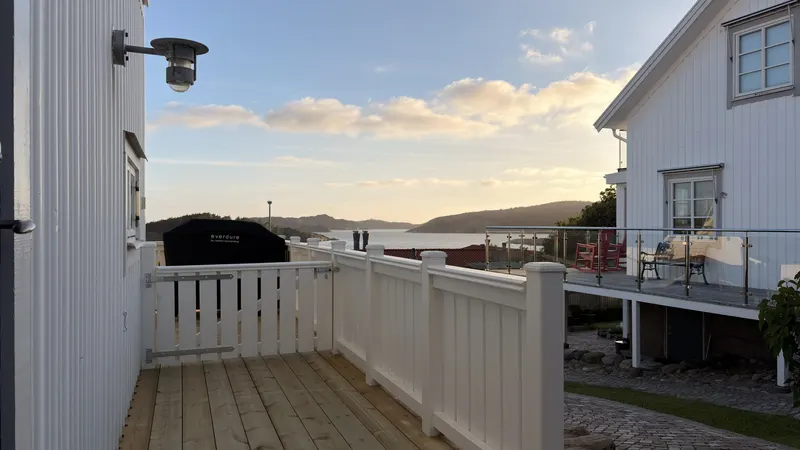Ny altan med vitt räcke och utsikt över havet